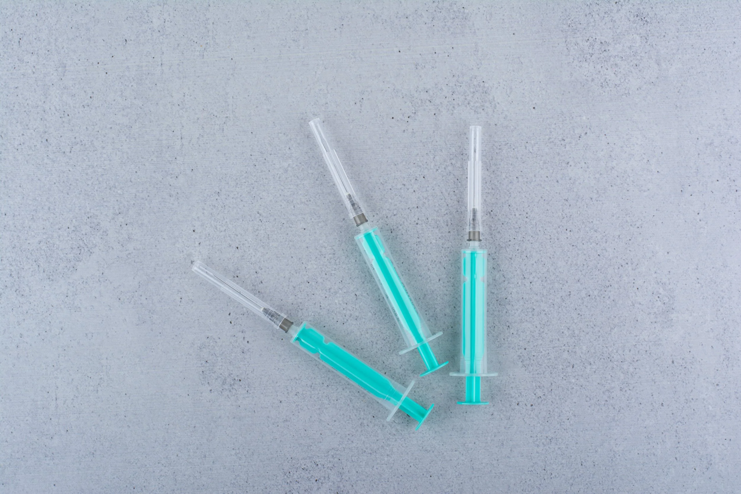 Close-up of three filled syringes representing injectable weight loss medications used under clinical supervision.