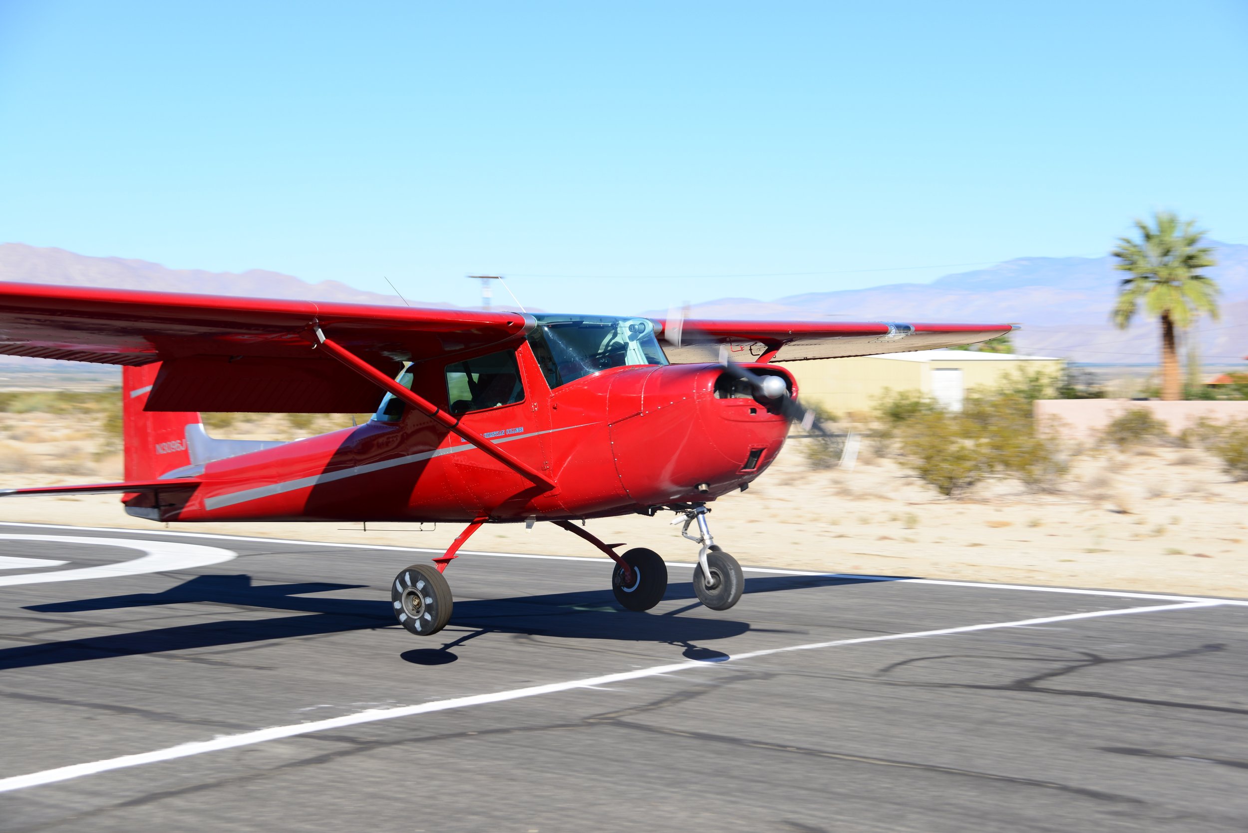   C-150 “Little Red' touching down close to landing line at Borrego Air Park during Spot Landing practice 2014  