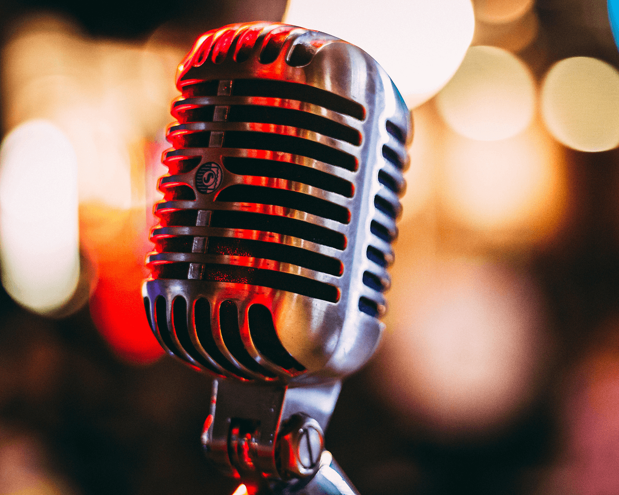 old fashioned microphone in front of blurred light background