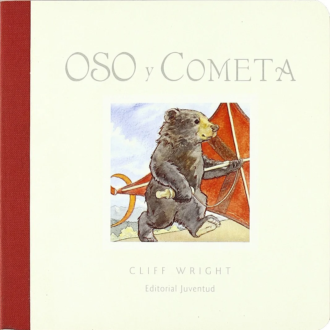 Portada de un libro titulado 'Oso y Cometa' con una ilustración de un oso pequeño caminando con un paraguas rojo.