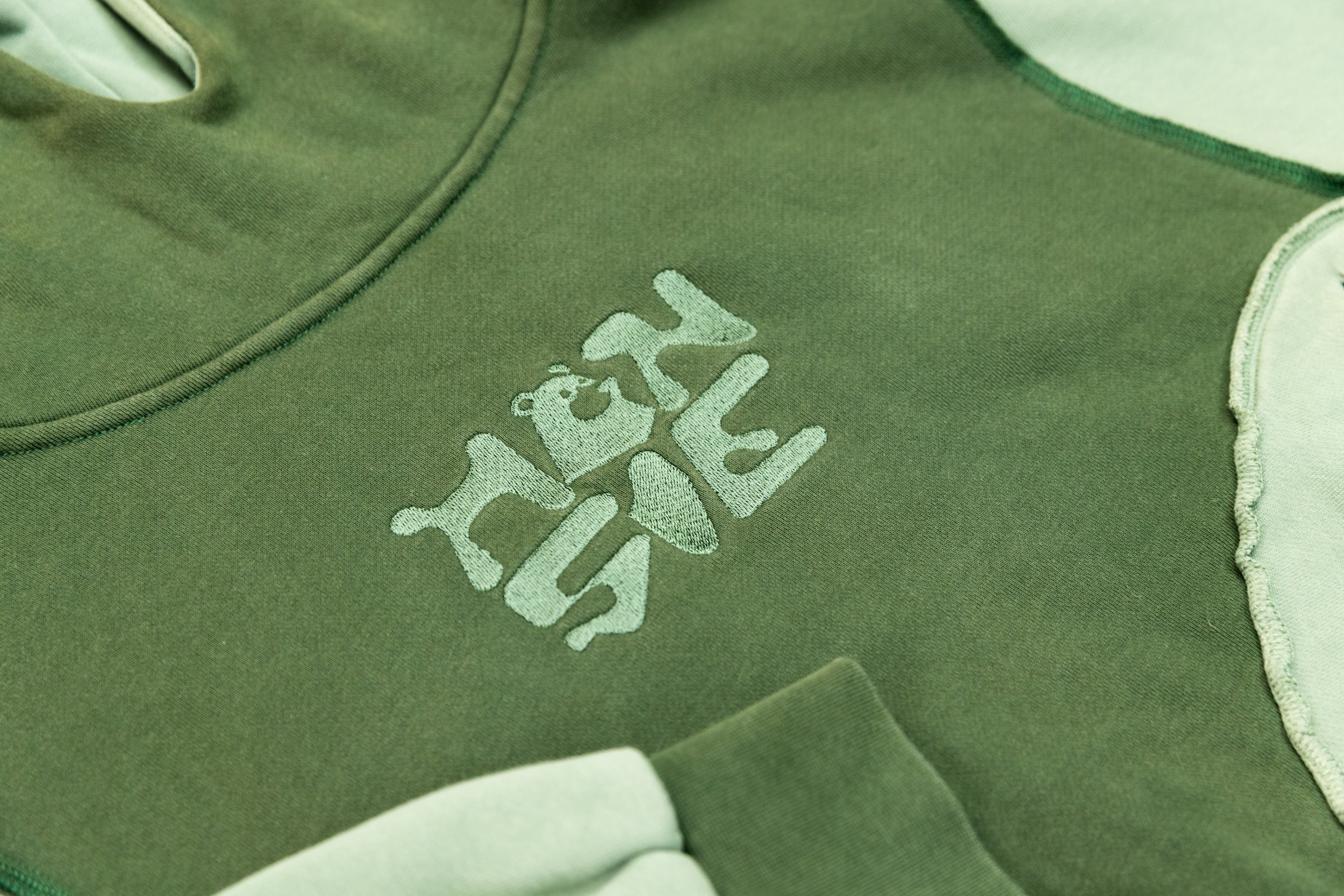 Close-up of a green and white athletic shirt with a Nike logo and the word "LEVY" embroidered in light green on the front.