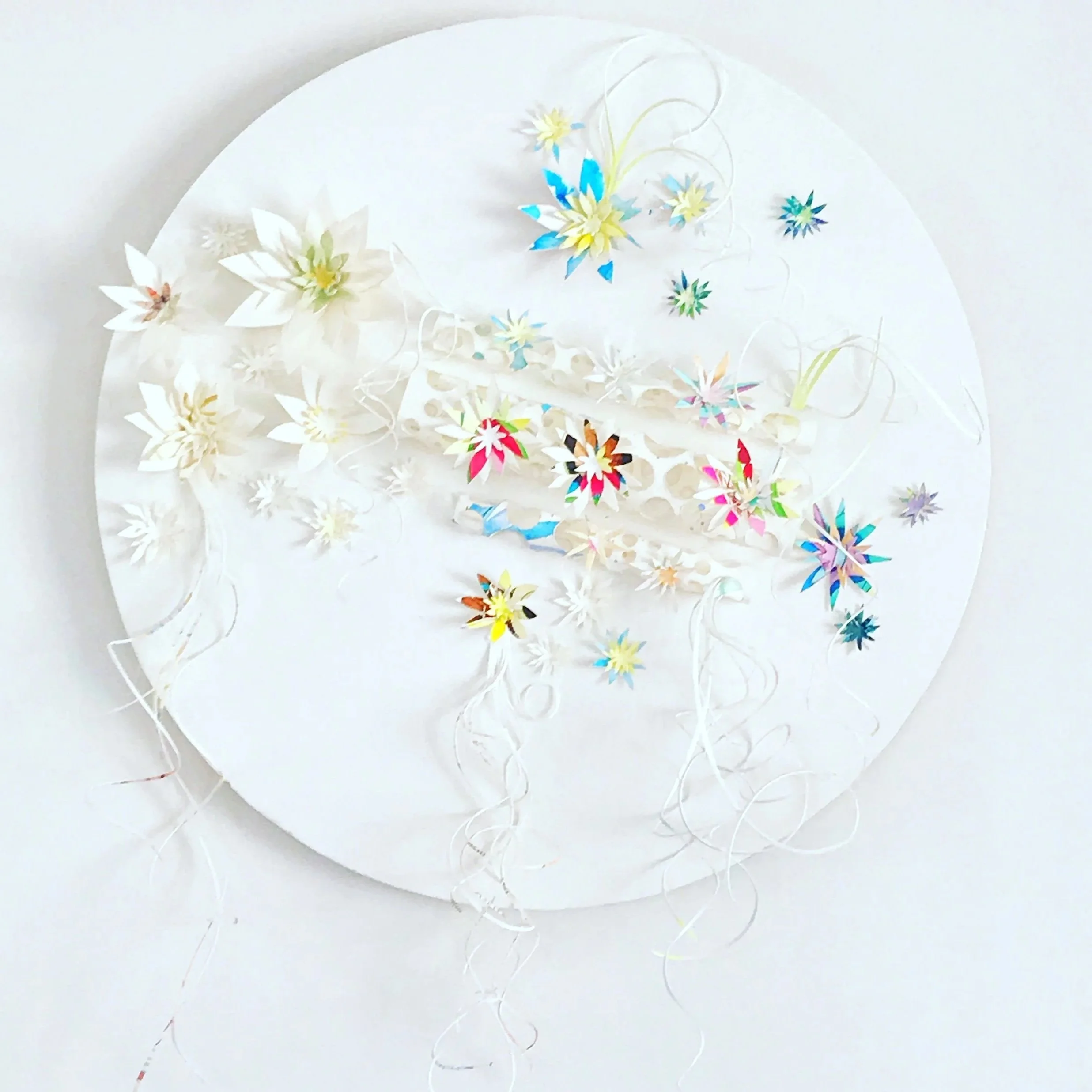 Wooden mandala wall hanging adorned with paper flowers and paper curls. Artwork by Leesa Maree.