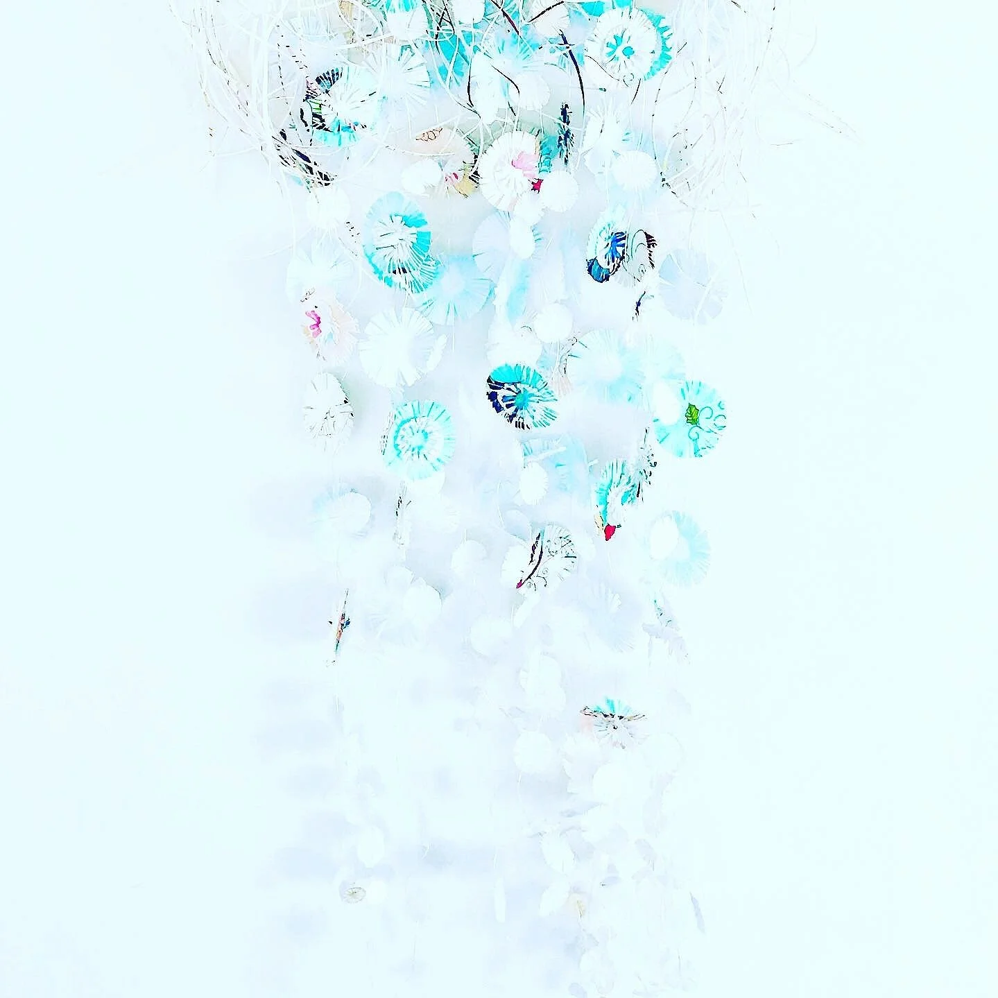Recycled paper delicately cut to replicate jellyfish tentacles. 