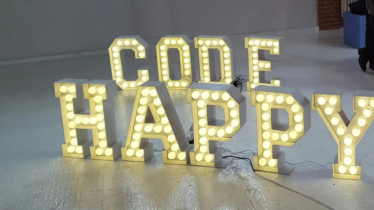 Code happy neon sign.