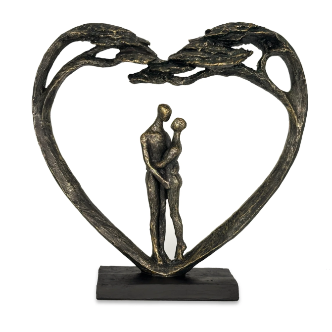 Couple Standing in Heart Tree Sculpture