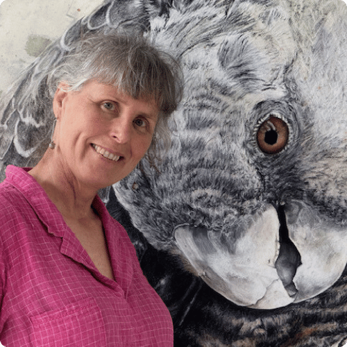 Jane is standing next to her painting of a cockatoo