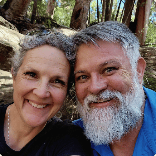 Kayte and Shane are snuggled together and smiling at the camera