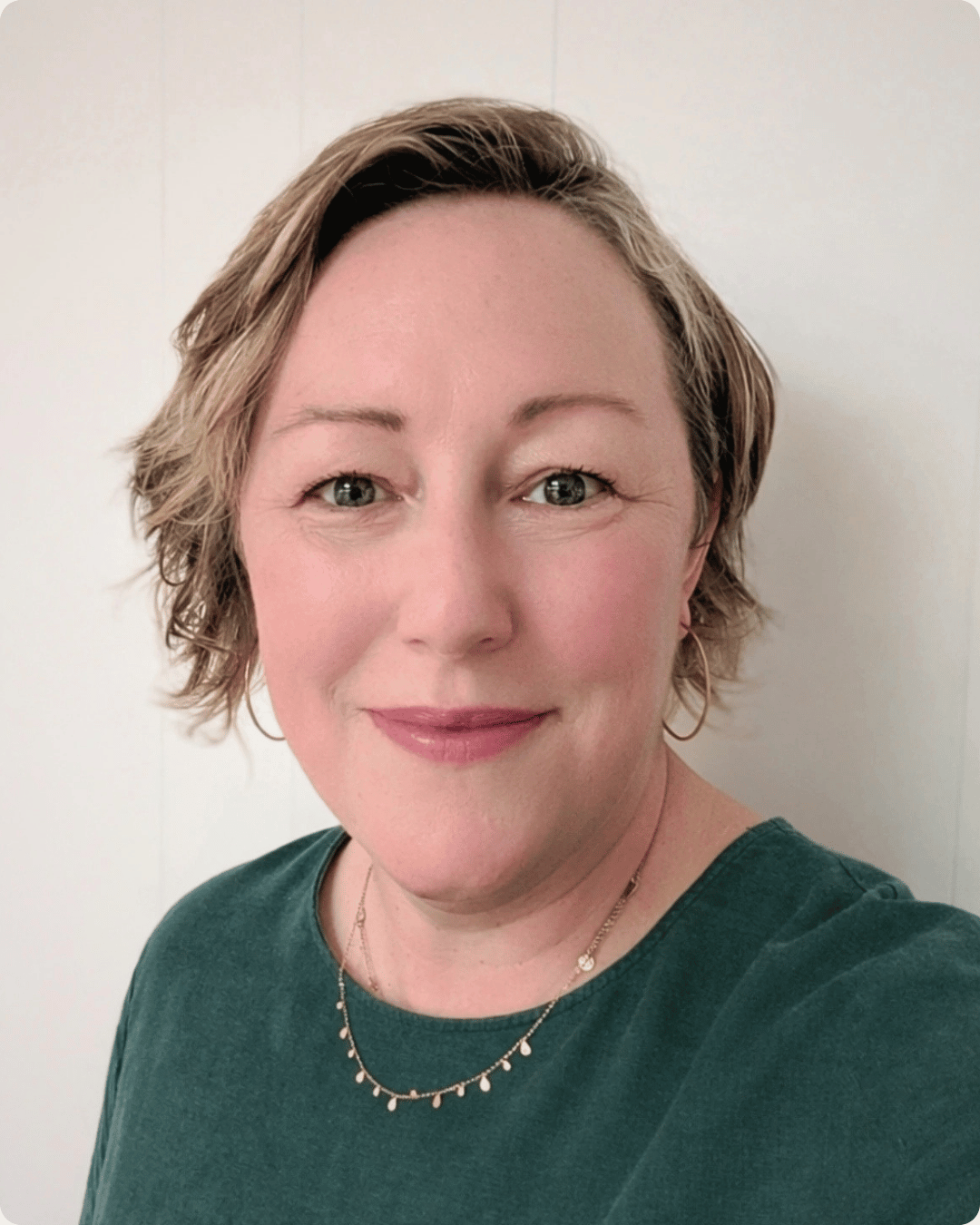 Kirsty she/her is smiling at the camera