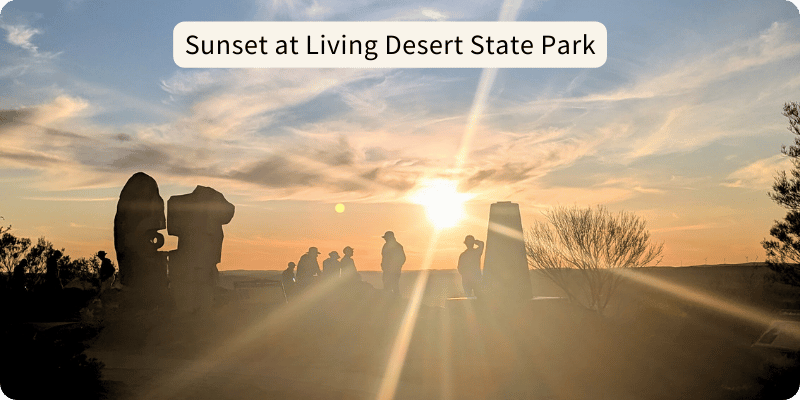 Sunset at Living Desert State Park, with the sun's rays shining through the sculptures