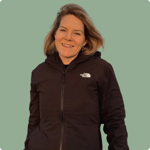 Claire is wearing her North Face hoodie and the background to her photo is green