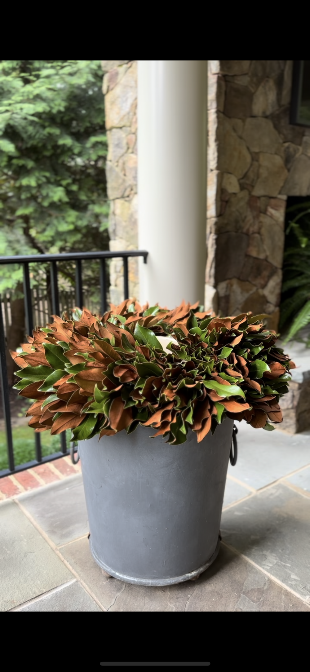 Magnolia wreath on rim of pot.PNG