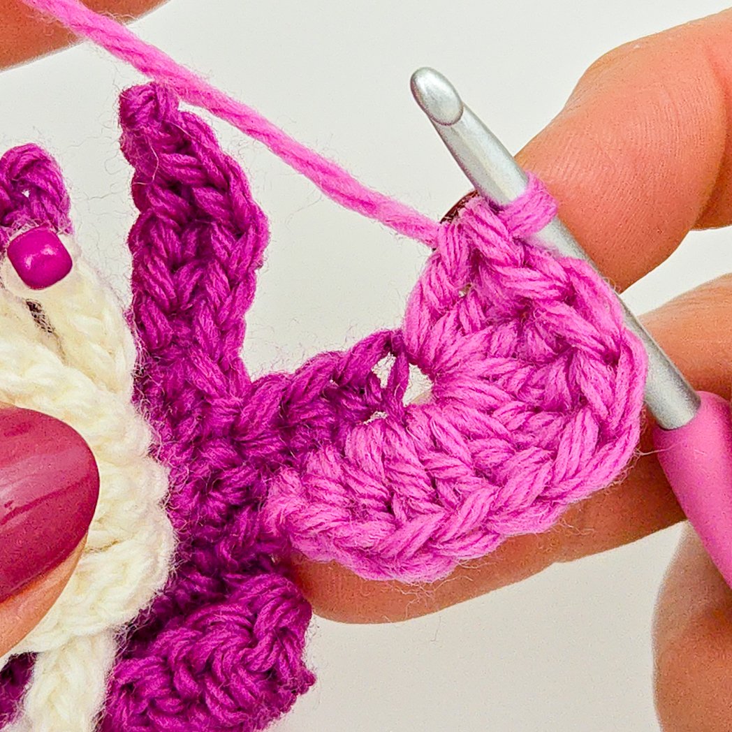 Working in chain-3 space at end of petal center.