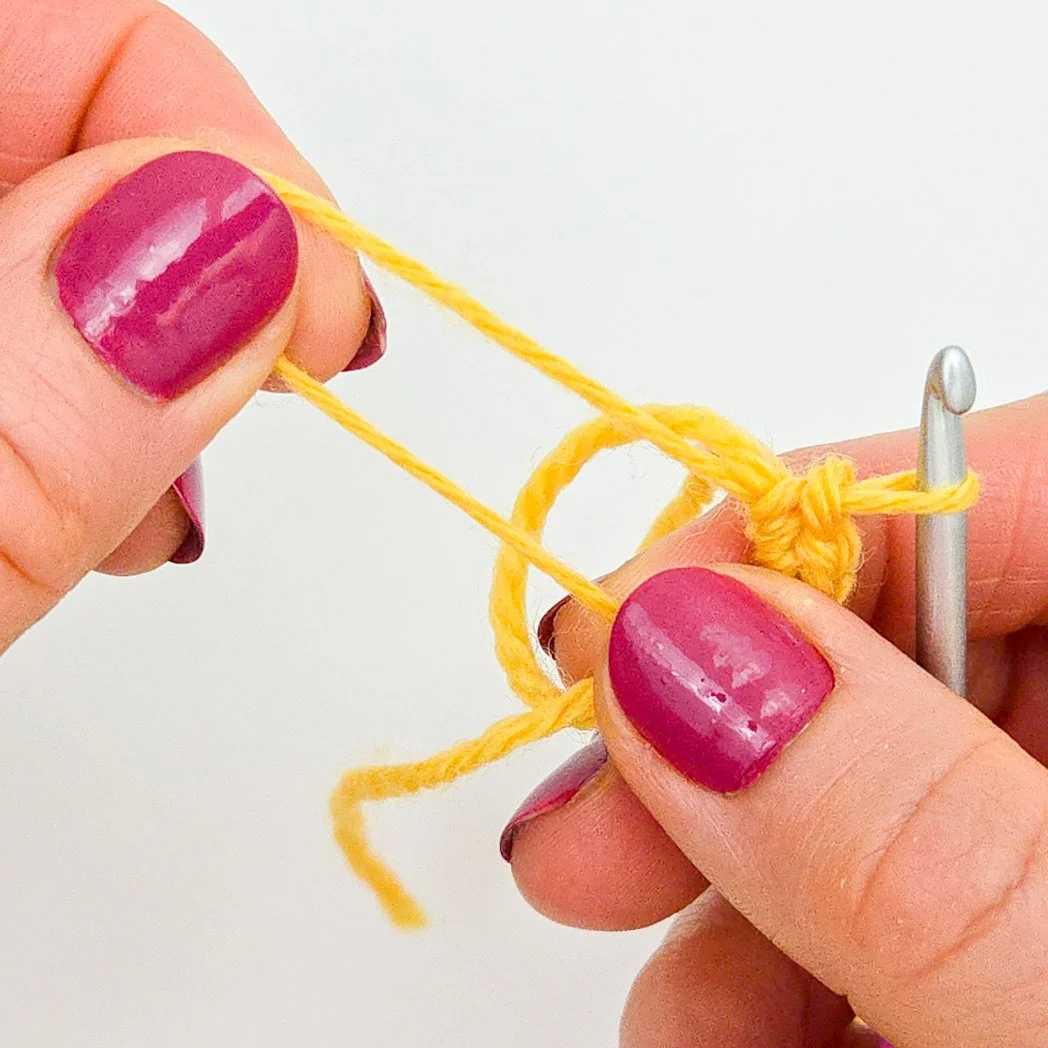 Pulling the smaller loop until the other loop closes.