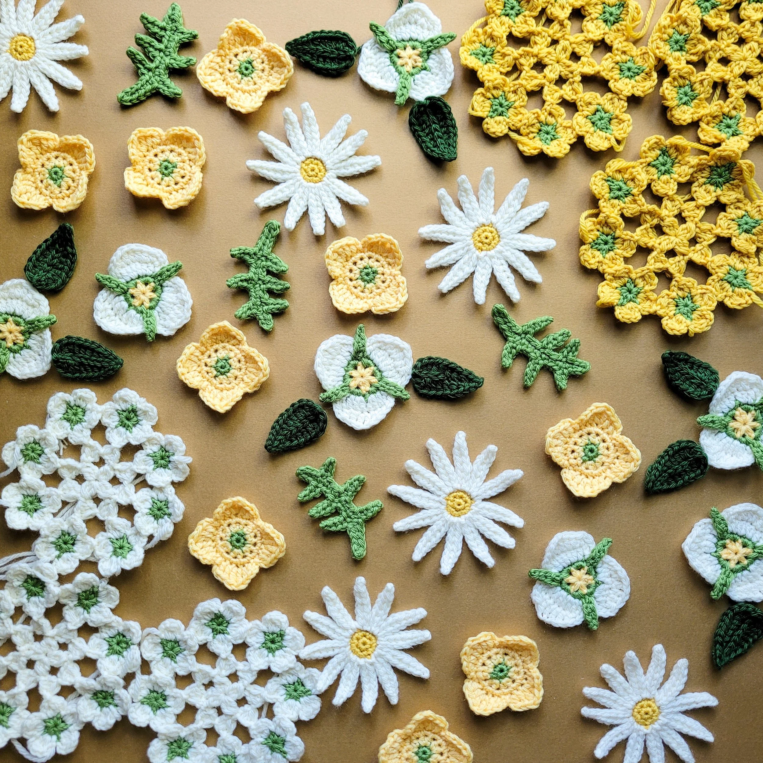 crochet flowers in yellow, white, and green