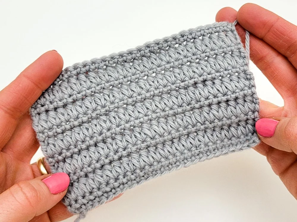 A swatch featuring the Forked Cluster crochet stitch pattern made with a gray yarn.