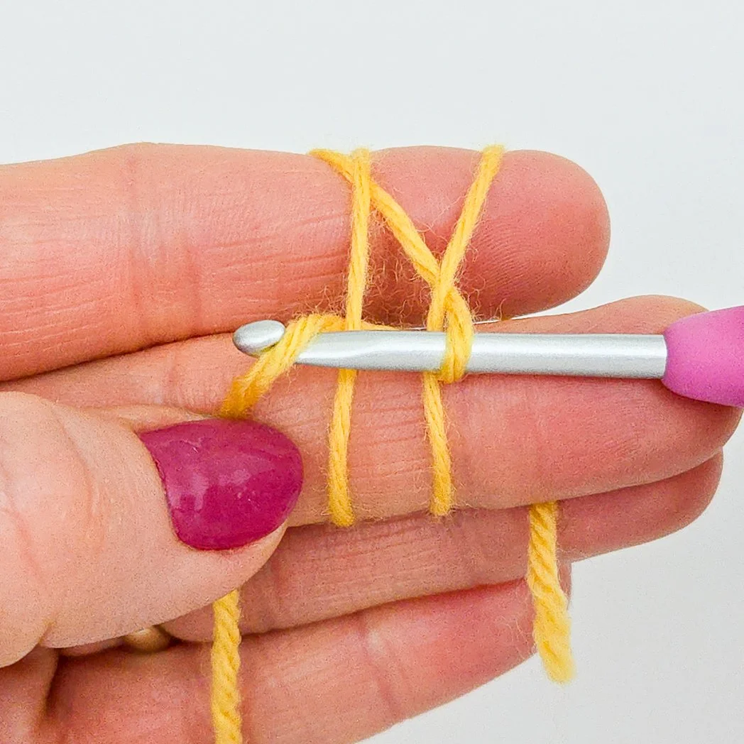 Yarn over with working end of yellow yarn.