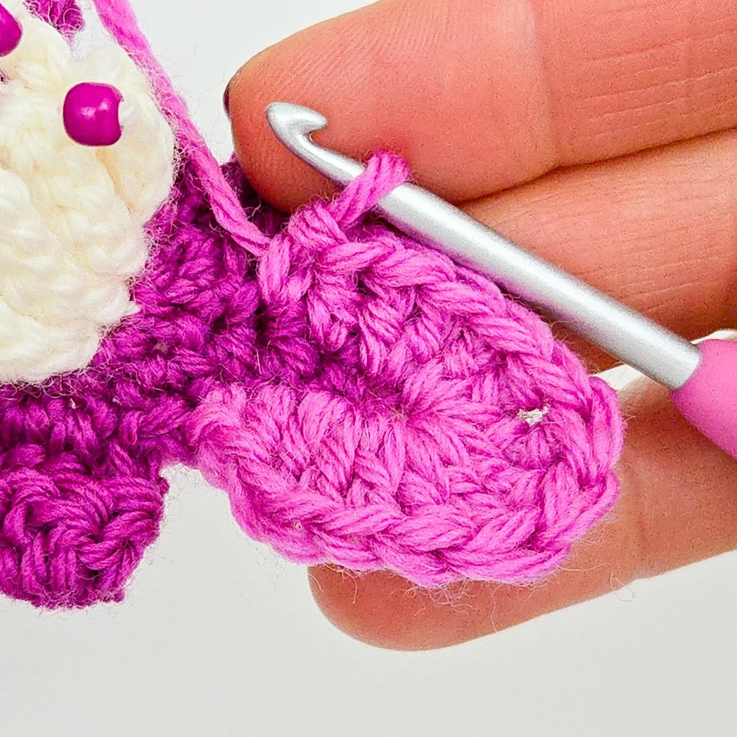 Working into the stitches of the petal center.