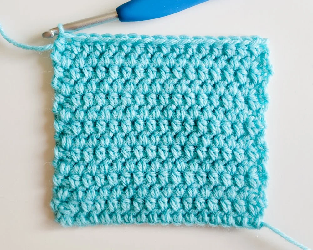 A crochet swatch made with the wide half double crochet stitch pattern. The yarn is light blue.