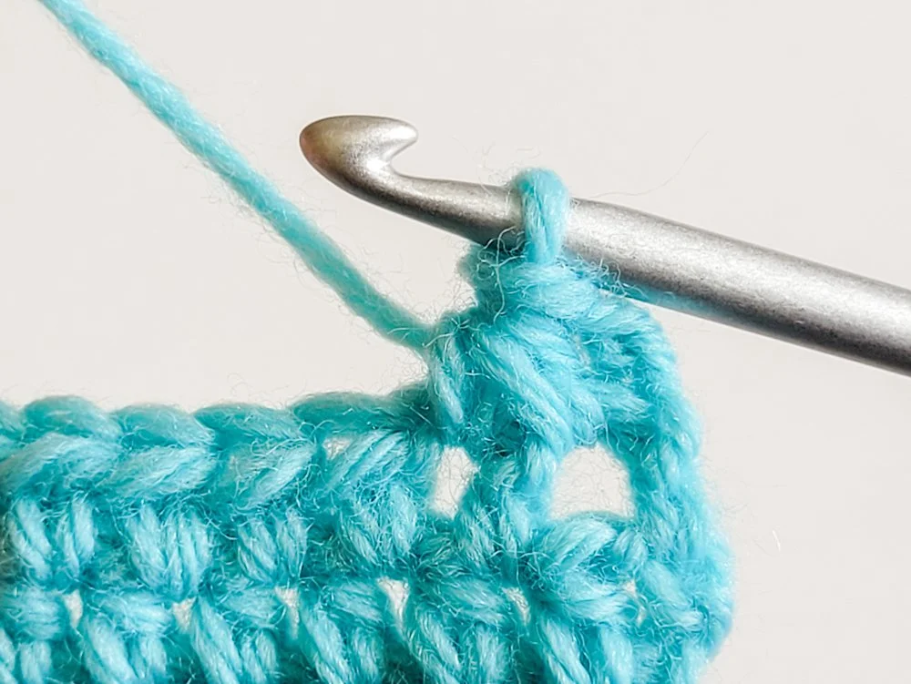 A wide half double crochet decrease completed.