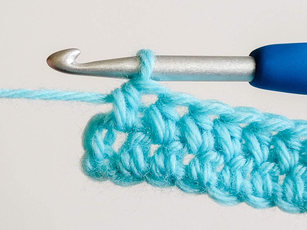 Hdc worked in the space between the last two stitches of the row.