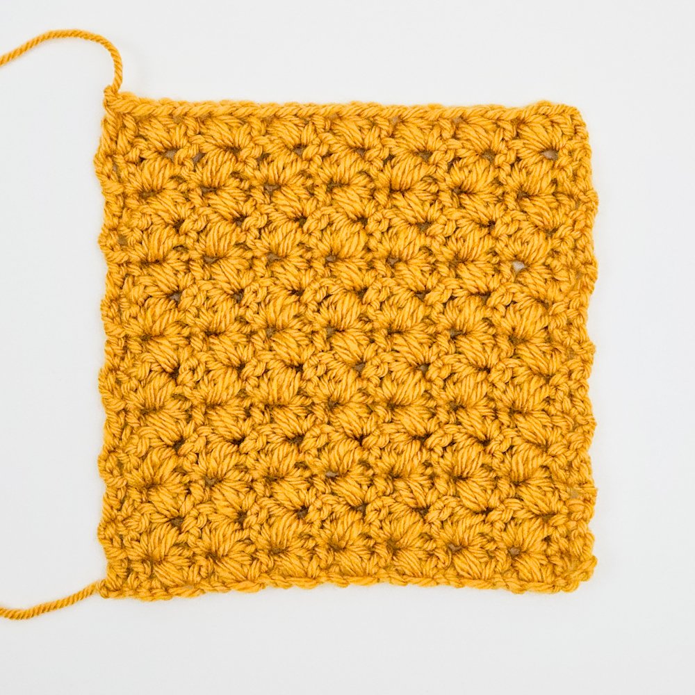 A yellow fabric swatch made using the Rocking Puff V-Stitch pattern.
