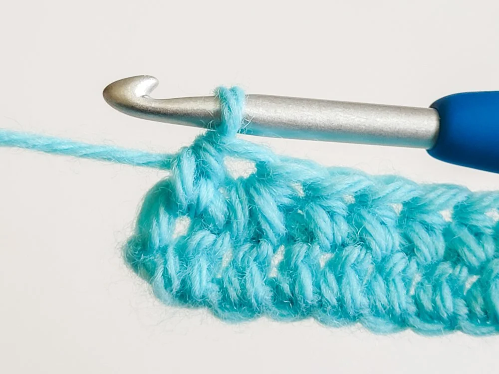 Last stitch of row worked into the space between the last two stitches.