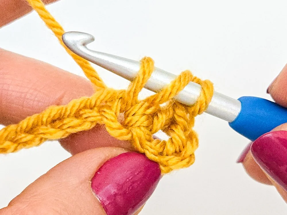 First step in working a puff stitch complete. Three loops are on the hook.