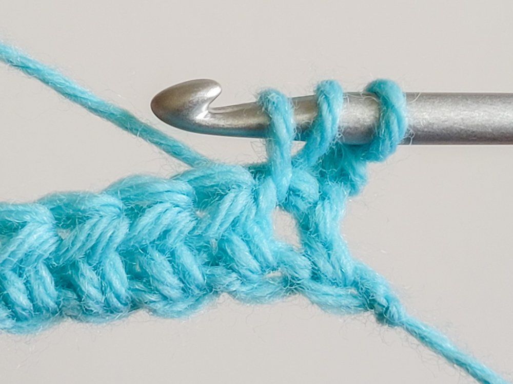 After pulling up a loop, there are three loops on the hook.