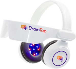 BrainTap headset with a white strap and ear cups, featuring a circular, illuminated, multi-colored LED design on the ear cup.
