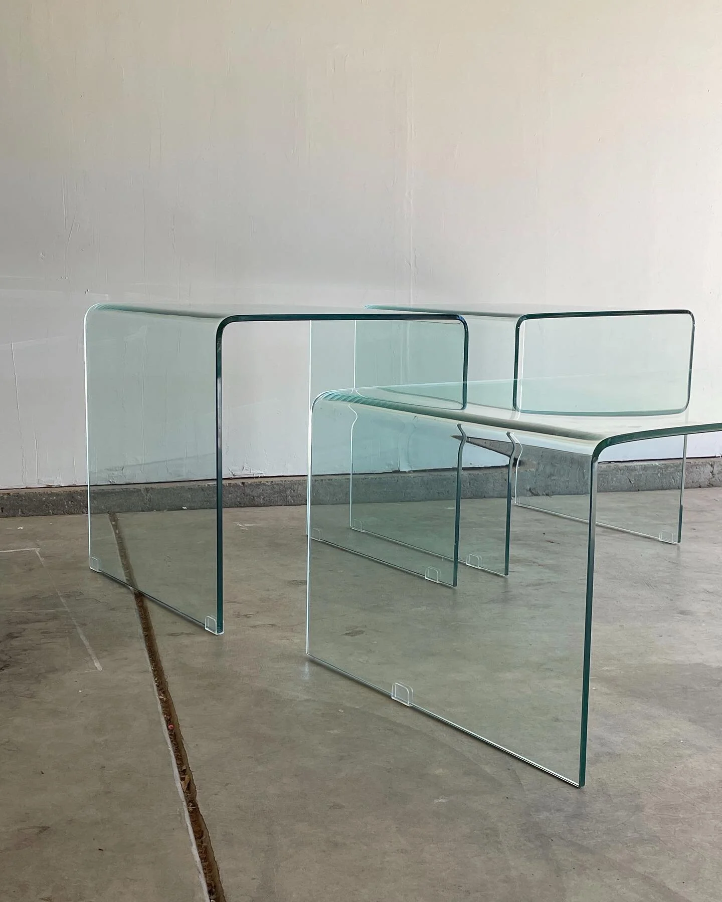Vintage 1980s Waterfall Glass Tables

Circa 1980s post modern waterfall glass tables. (2) end tables and (1) coffee table. These pieces are in incredible vintage condition - no cracking or chipping of the glass.
⠀⠀⠀⠀⠀⠀⠀⠀⠀
LOCAL BAY AREA PICK-UP &amp;
