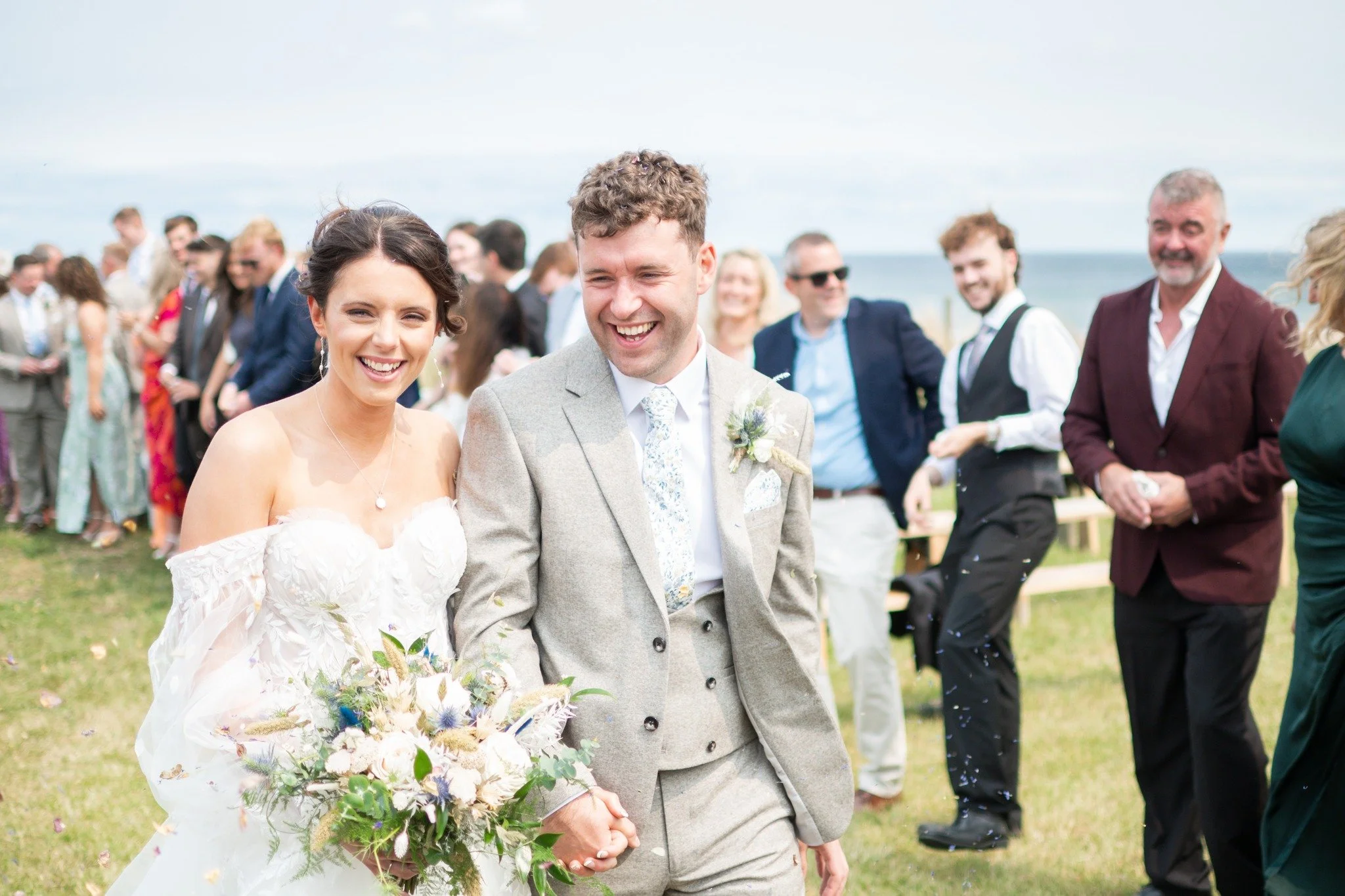 Beach weddings don't actually have to be on the beach, they can be overlooking the sea in the beautiful dunes like Anna and Harry at @barnonthebay_weddings .

Then if the weather behaves, (well, we are in England) you can stroll hand in hand along th