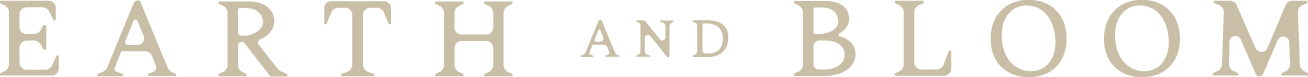 Part of a text logo with the words 'EARTH AND BLOOM'