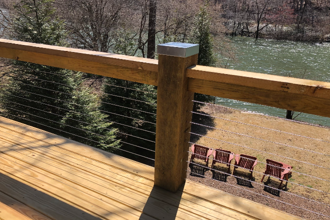 A wooden decking installation with a pond in the background