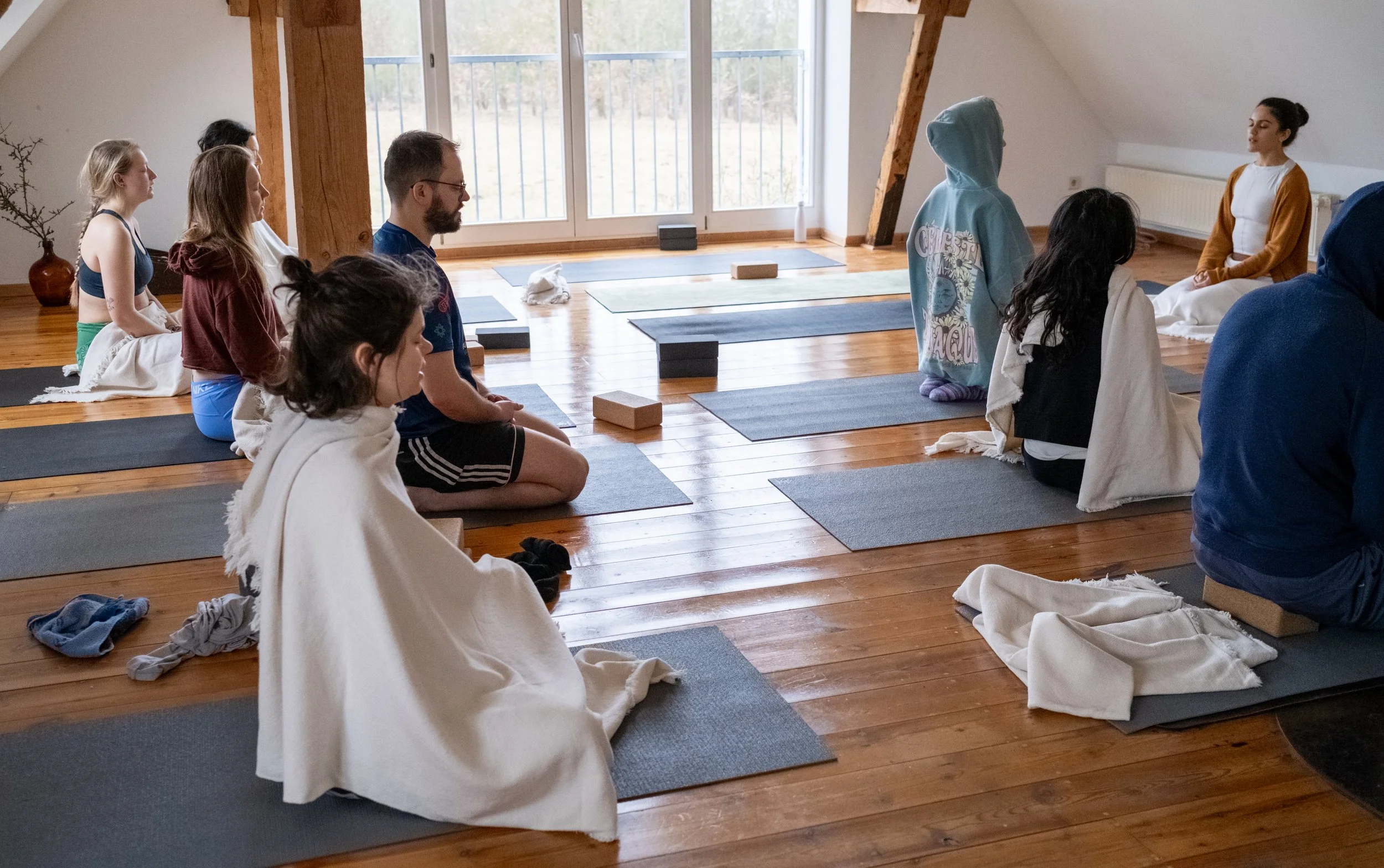 Group practicing restorative yoga in a retreat centre