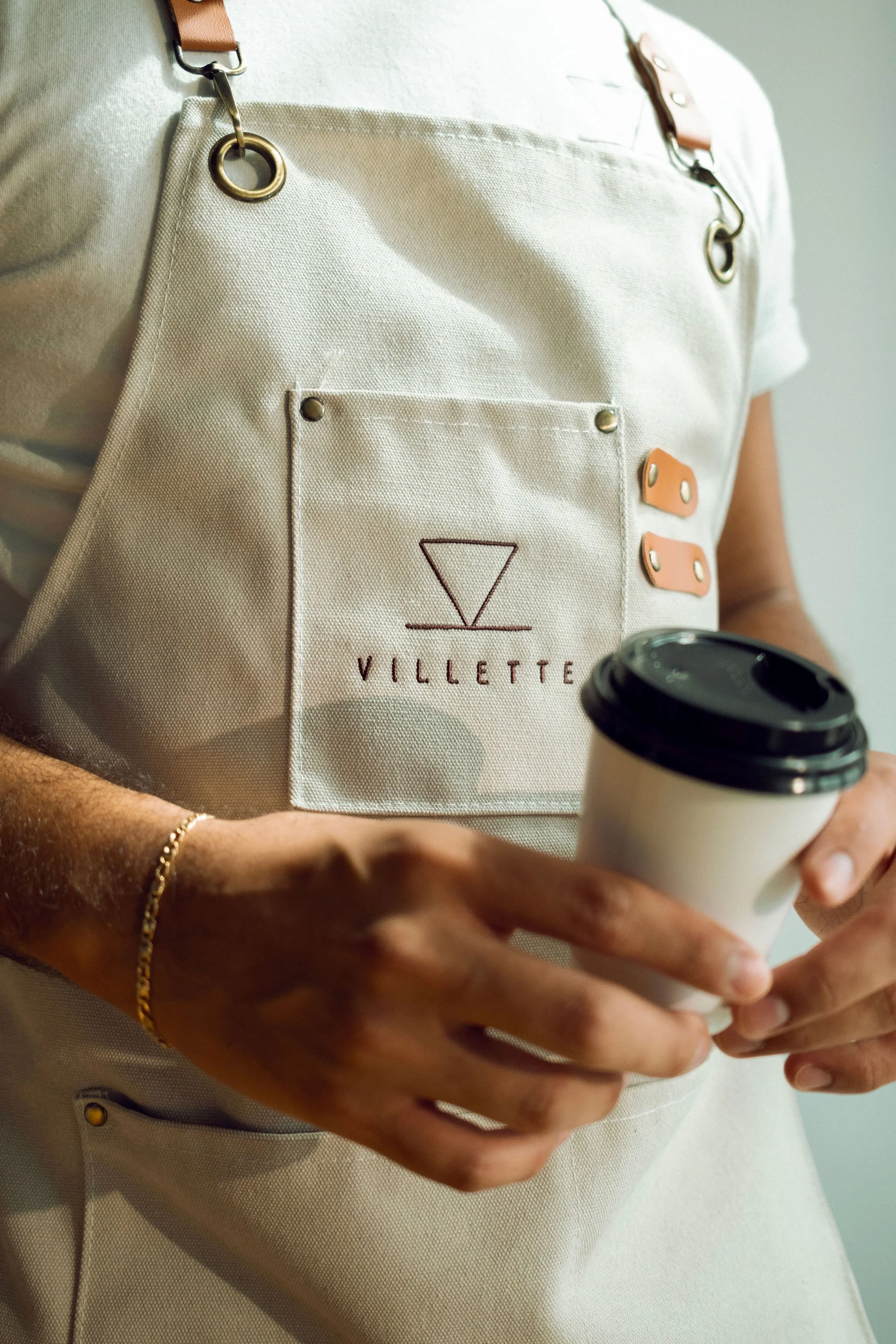 Villette Coffee Cart barista holding a coffee cup at a Miami event
