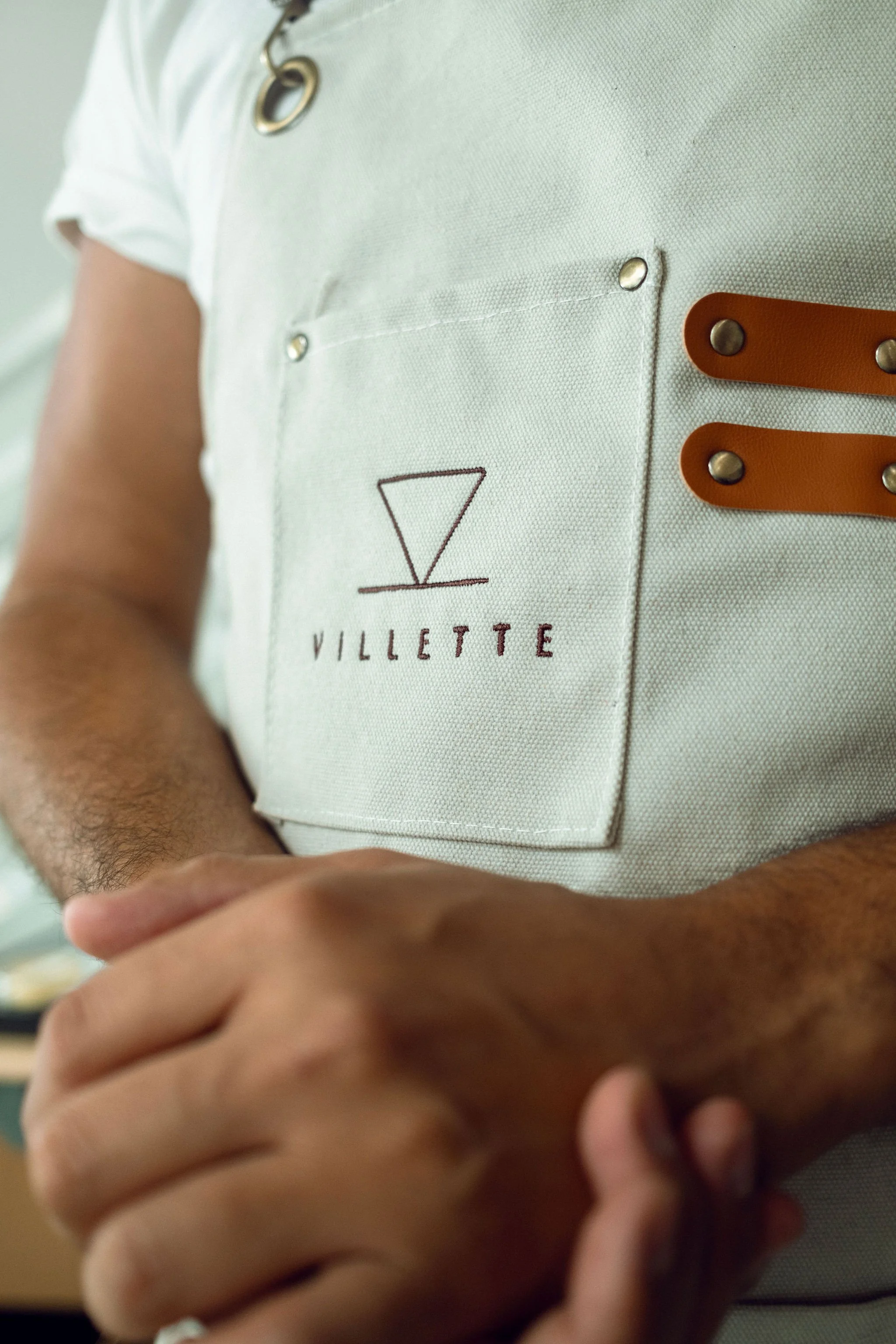 Close-up of a Villette barista apron with the logo on the chest pocket