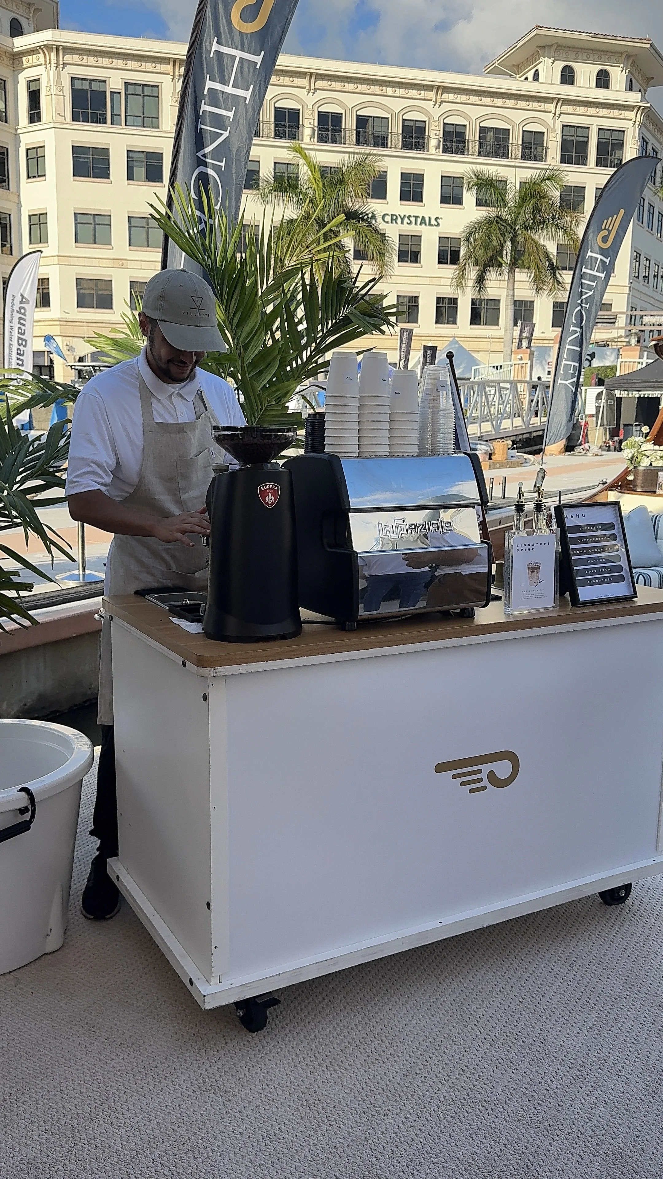 Specialty coffee service with professional baristas serving handcrafted beverages at West Palm Beach Boat Show