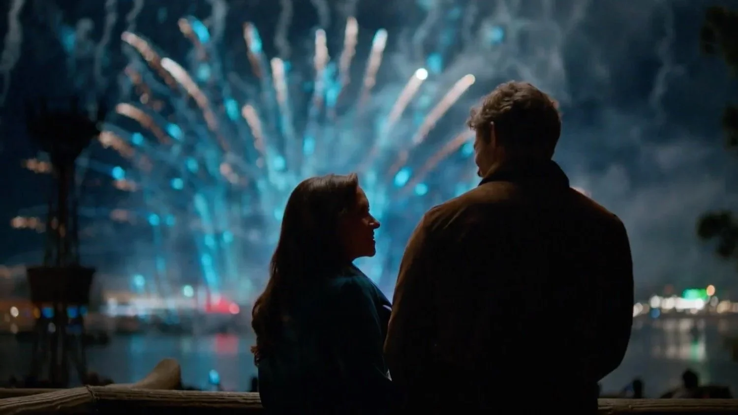 Silhouette of a woman and a man facing each other at night with a fireworks display in the background from Holiday Ever After | Written & Directed by Ryan Landels