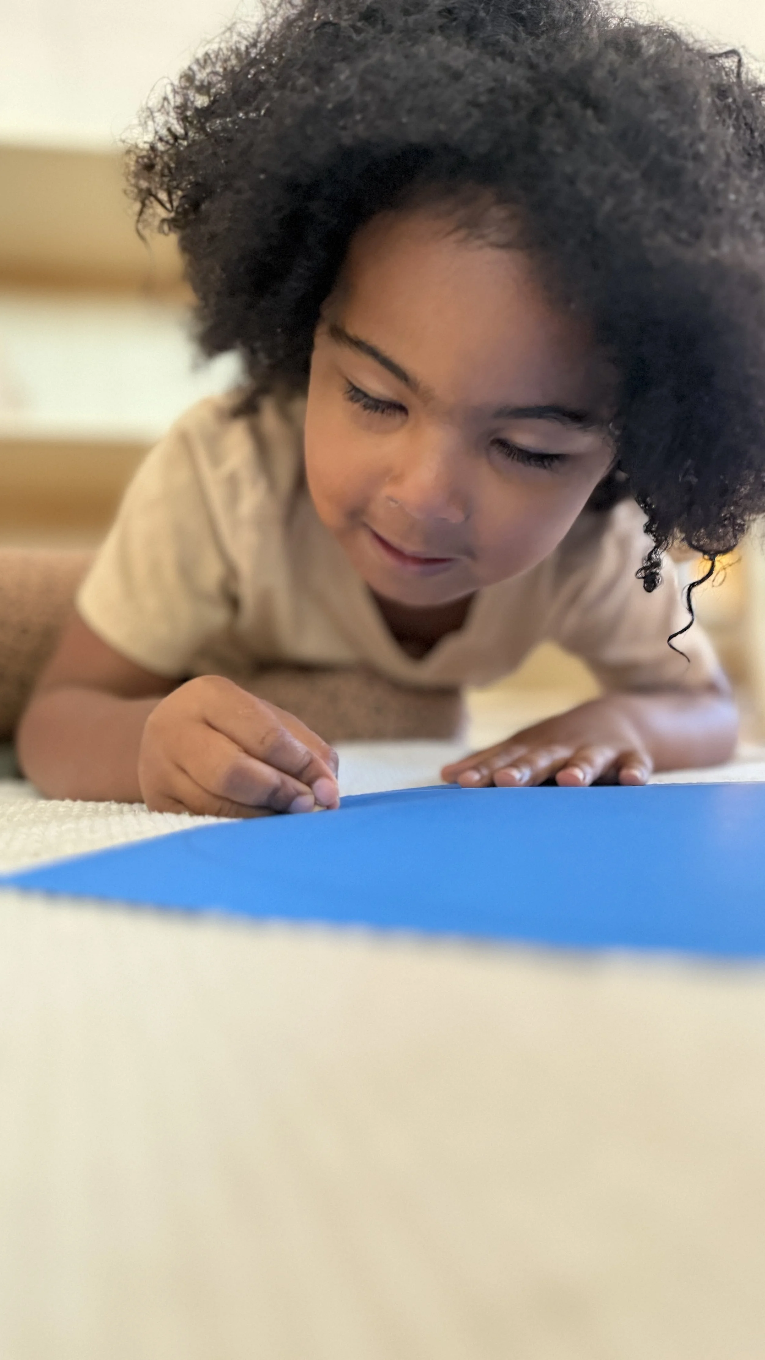 Montessori primary student pin punching