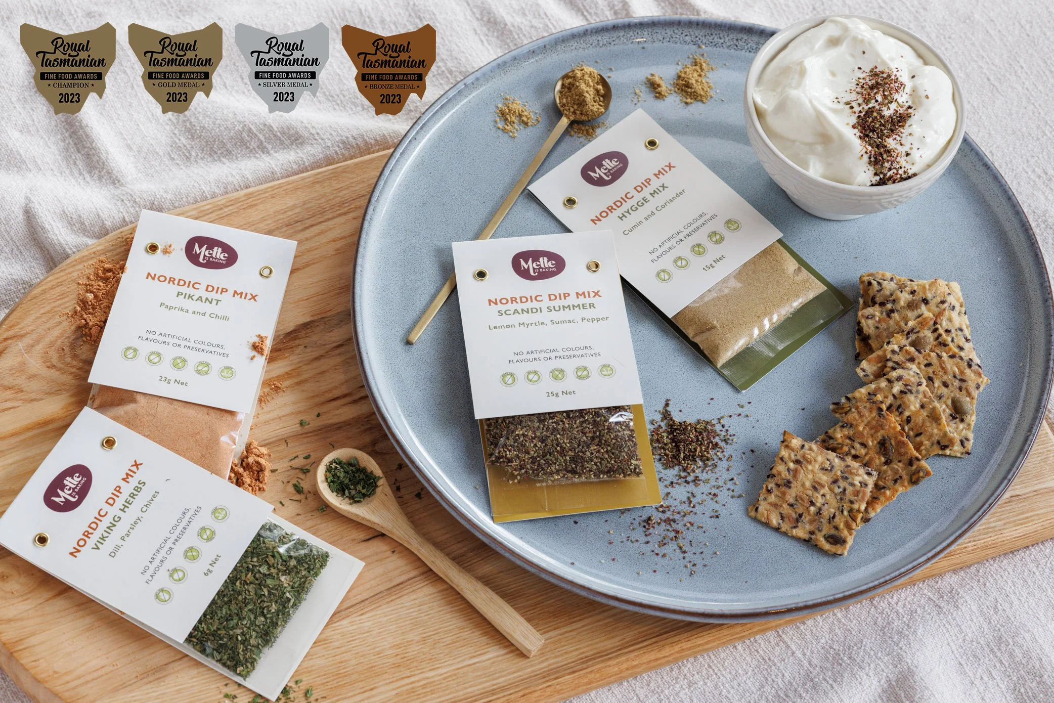 crackers and dips on a plate with spices and seasoning in packets as a dip mix