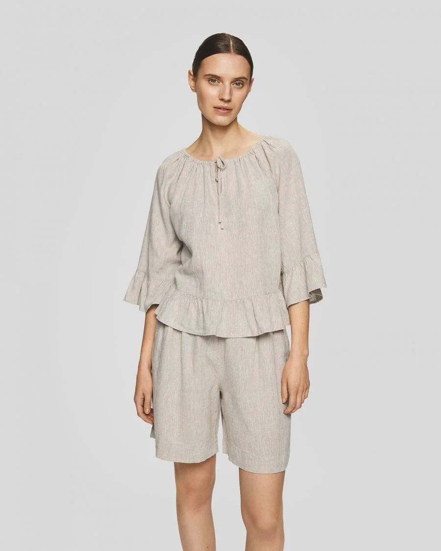 Vrouw met MSCHViana Ginia hoge taille shorts in beige kleur van Moss Copenhagen.