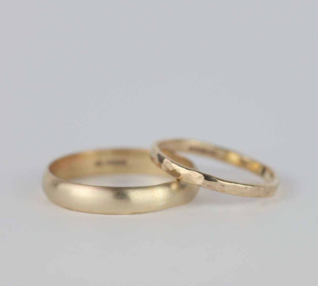 slim hammered yellow gold ring and wide half round gold ring