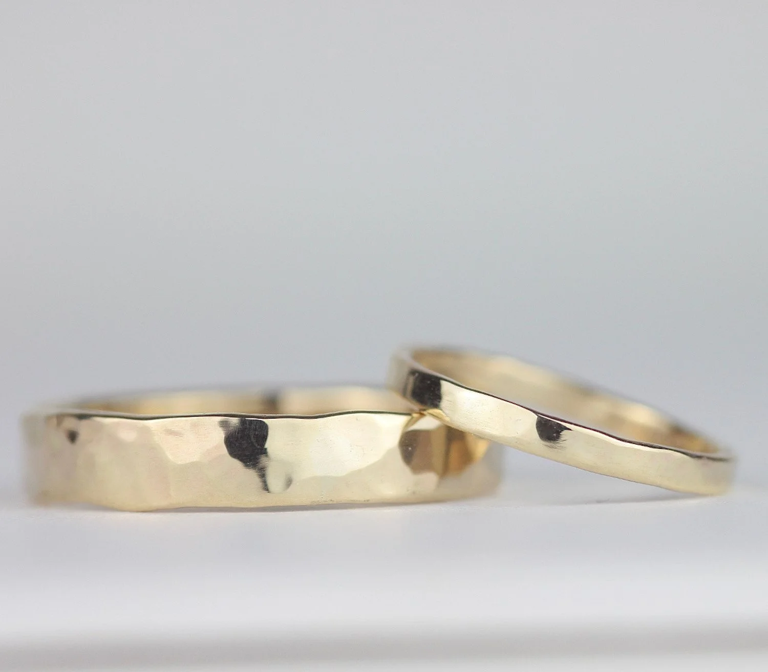 slim hammered yellow gold ring with wide hammered yellow gold ring