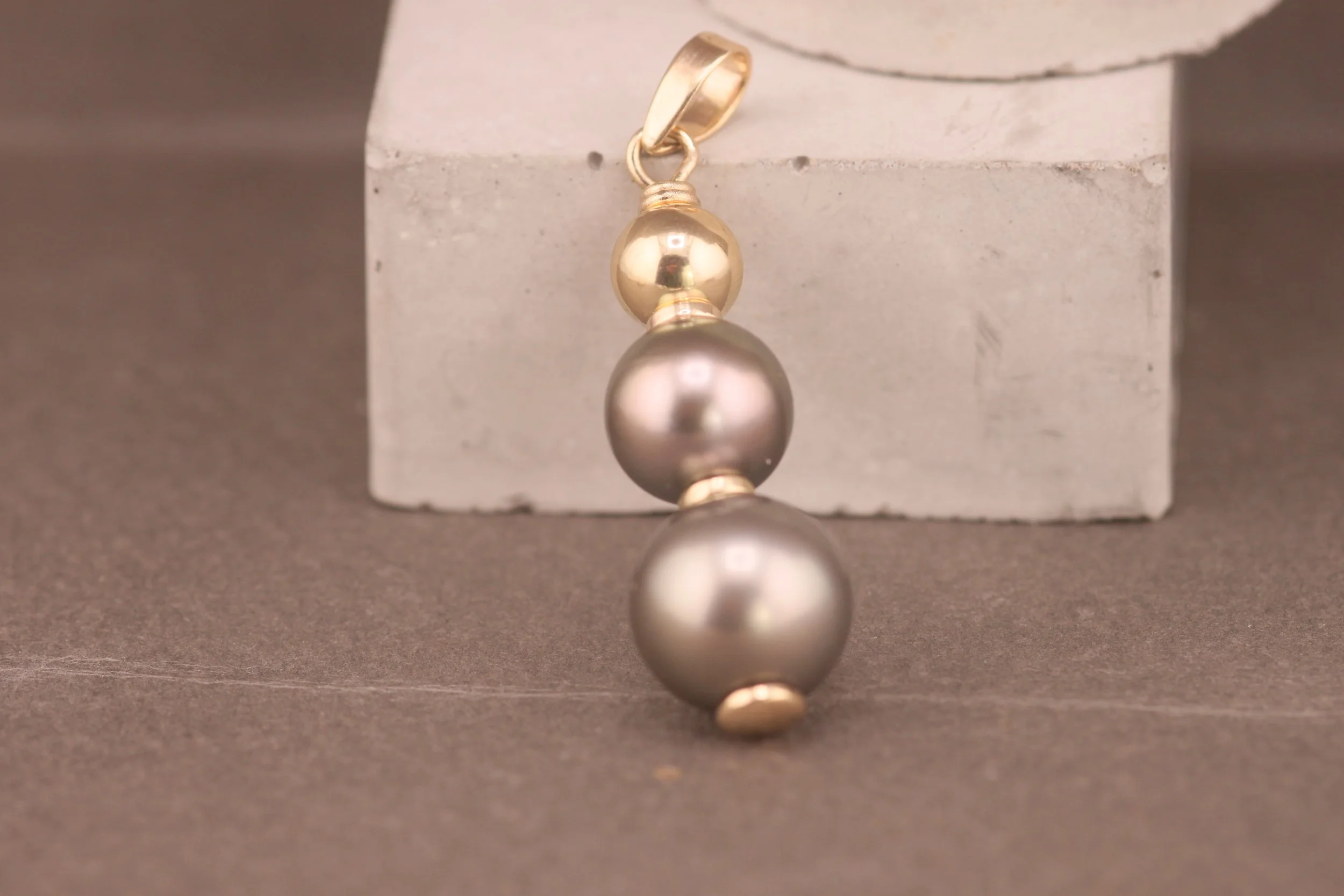 Black pearl pendant with 14ct gold accents handmade from inherited pearls in a bespoke jewellery remodelling project