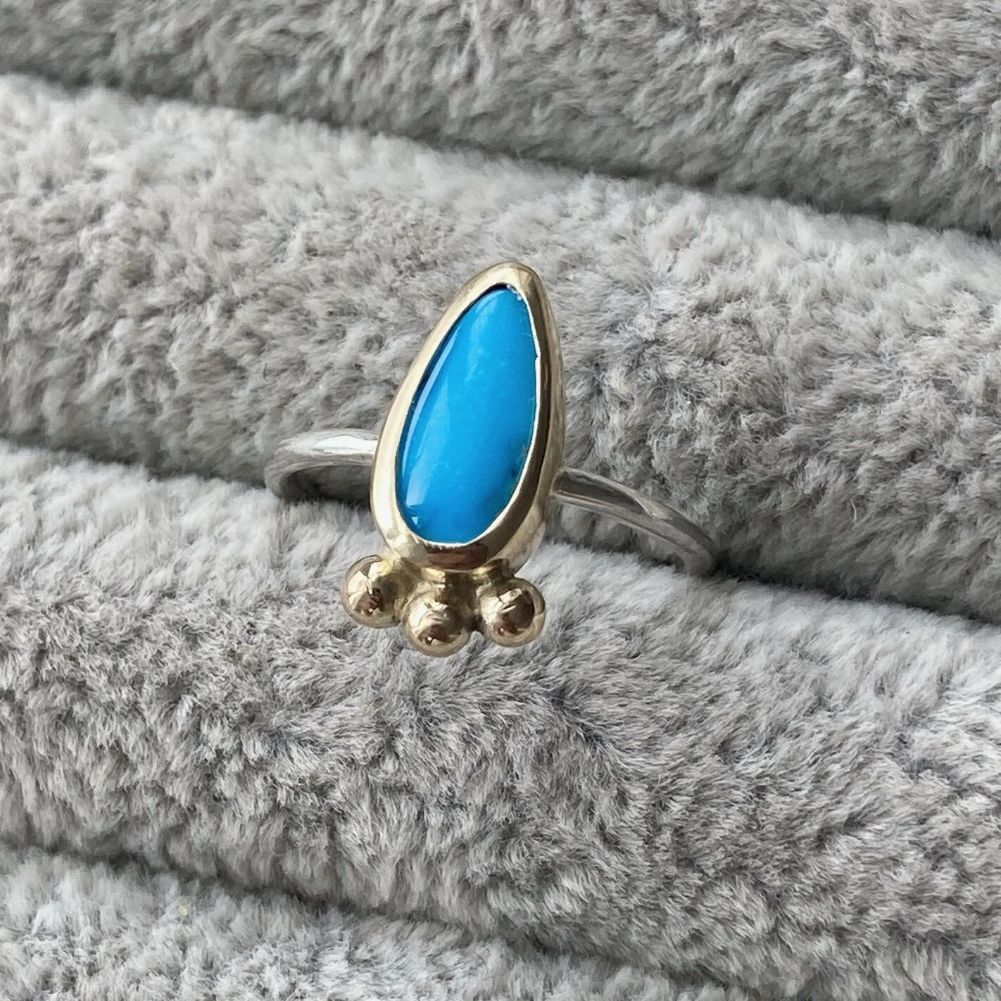 Small pear shaped turquoise gemstone ring in gold and silver