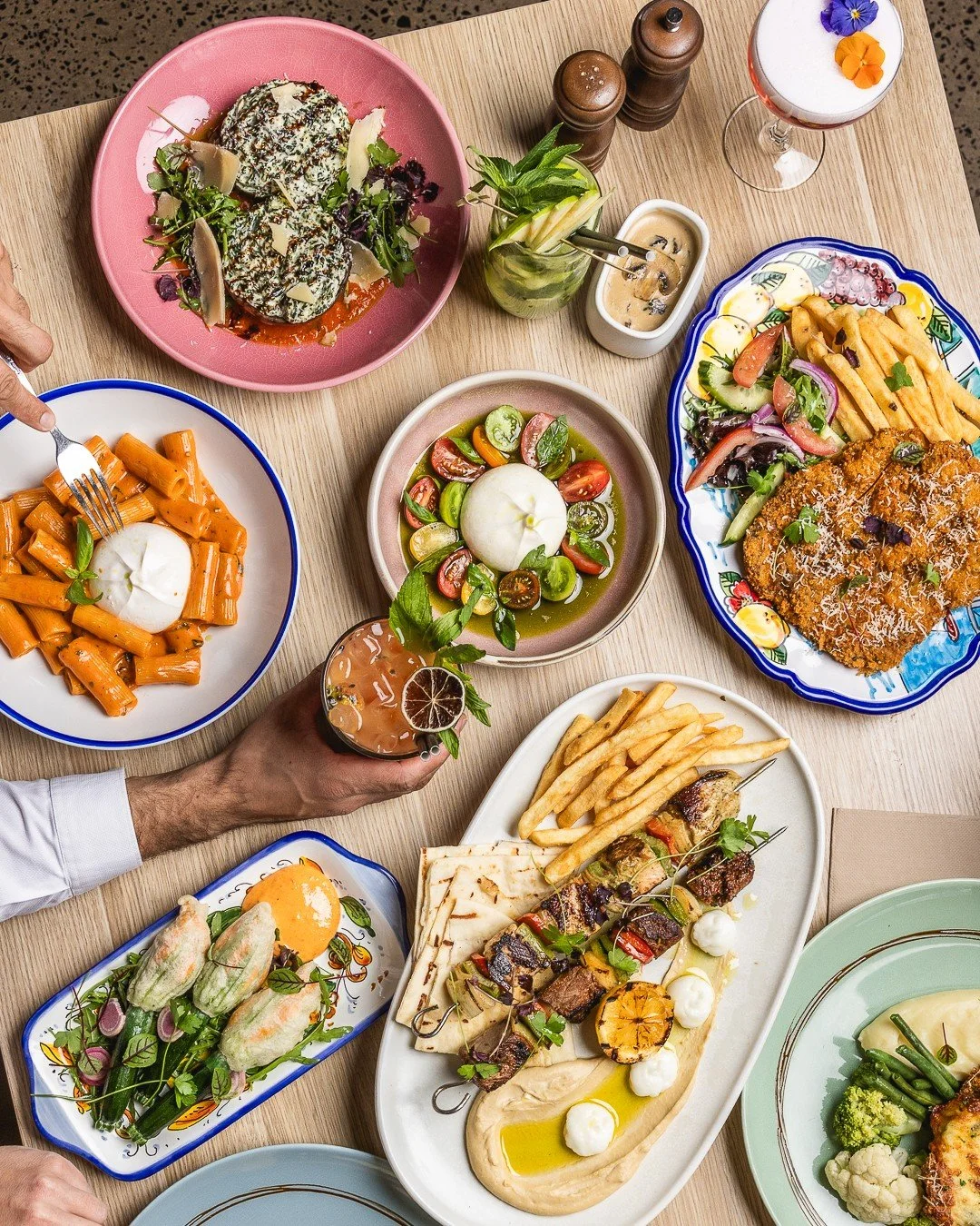 Can&rsquo;t decide? Neither can we 🍝✨

From creamy burrata-topped rigatoni to crispy schnitties and flame-grilled skewers, the @poppitino  table is officially fully loaded. Pro tip: always leave room for a cocktail (or three)🍹 

Tag the friend who&