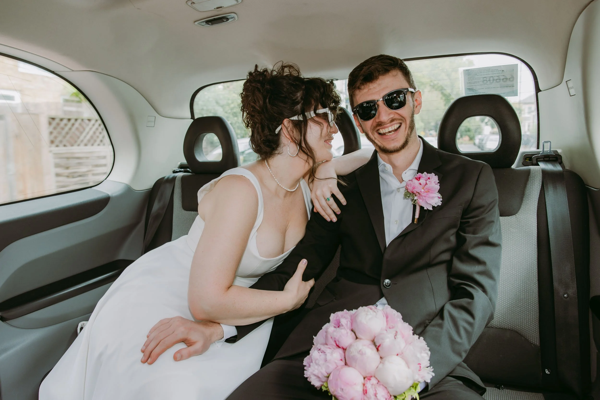 bride and groom in black cab on the way to bruno wine bar