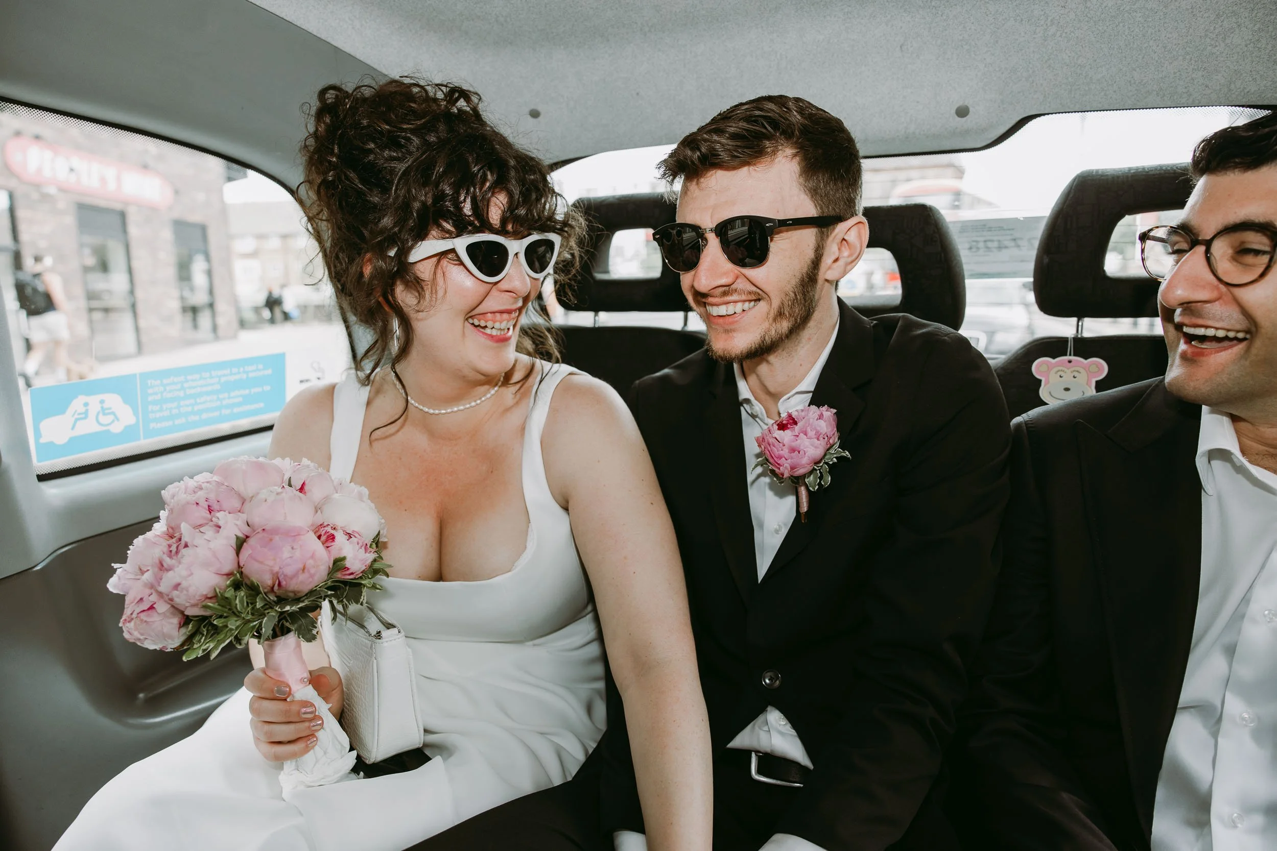 Bride and groom in taxi before Hackney Town Hall wedding in London