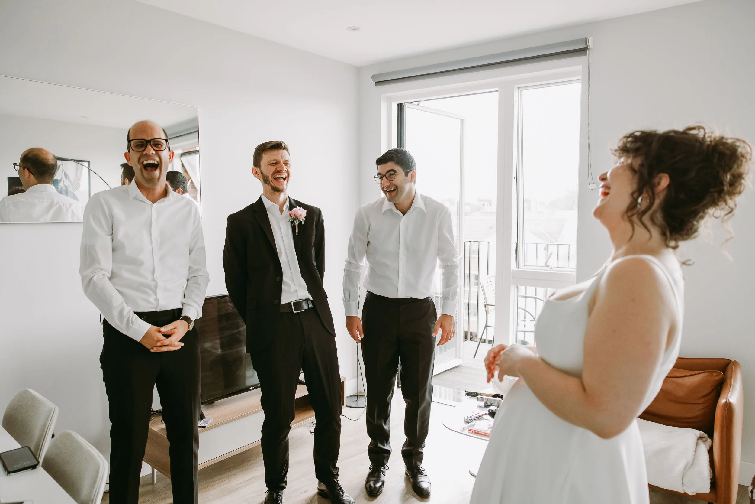 Bride and groom getting ready at home before Hackney Town Hall wedding in London