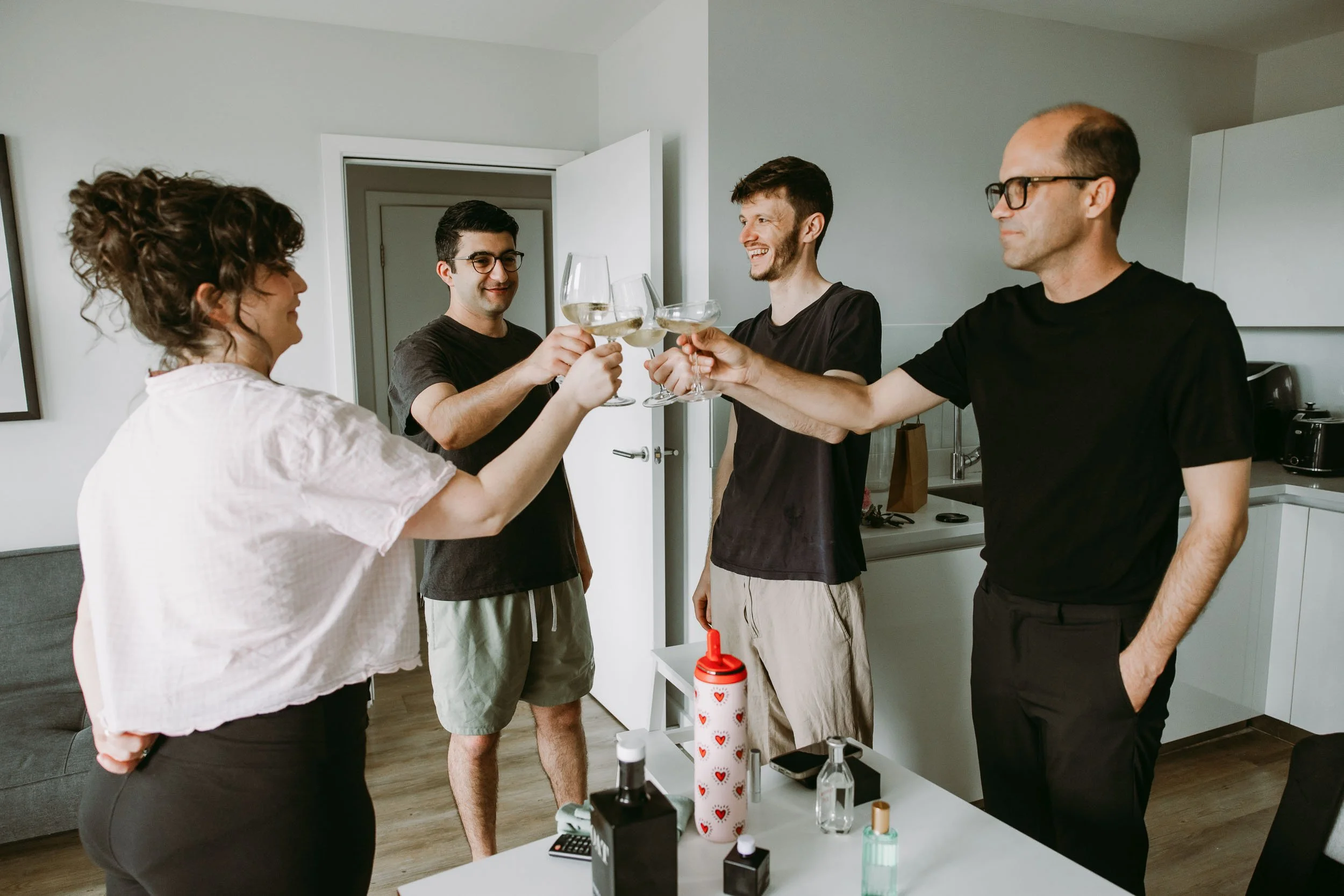 bride and groom cheers at home before getting married at hackney town hall